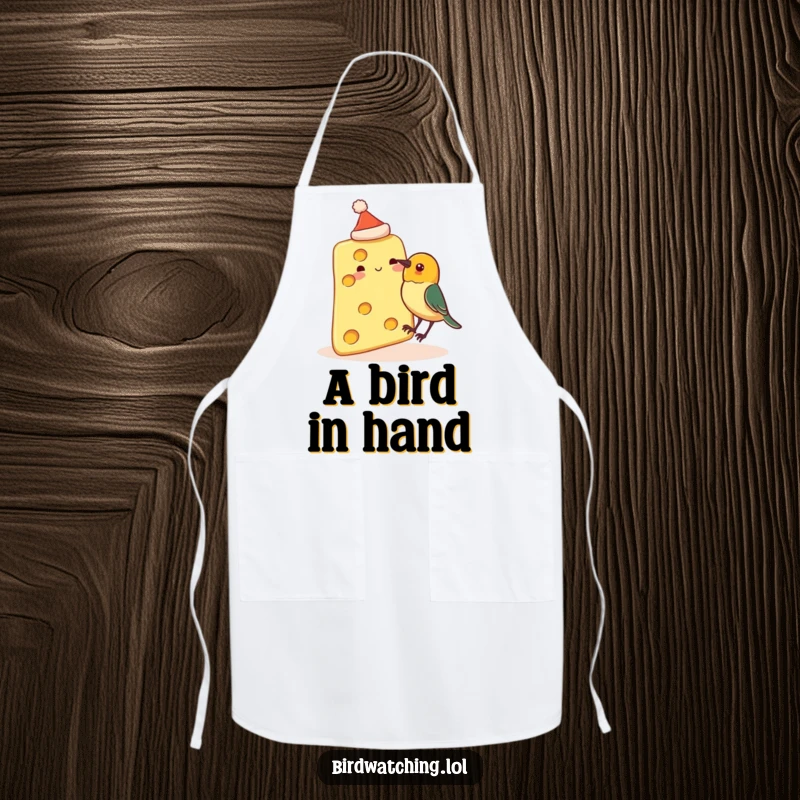 Funny kitchen apron with a slice of cheese wearing a tiny hat, about to be pecked by a curious bird, a humorous cooking accessory.