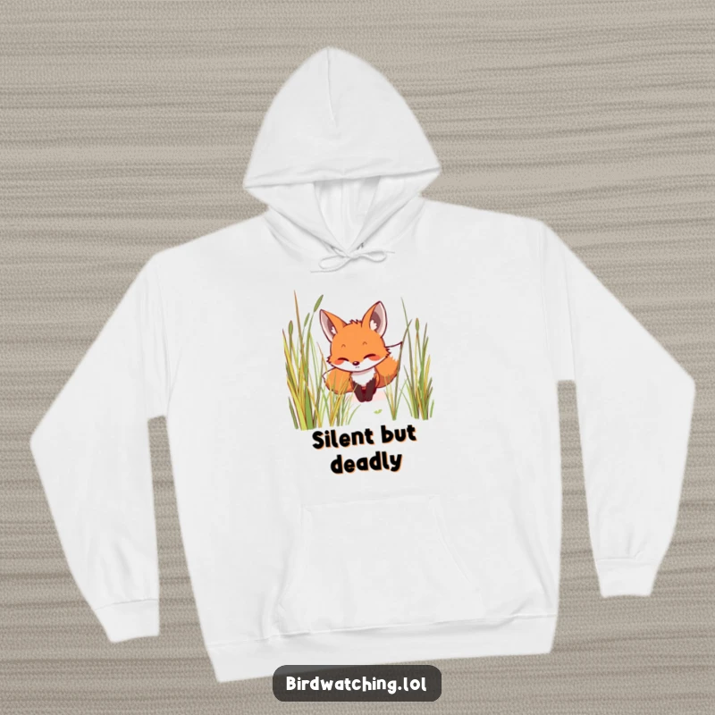 Funny hoodie depicting a smiling fox creeping stealthily through tall grass, focused and determined, a humorous and warm apparel item for gifting.