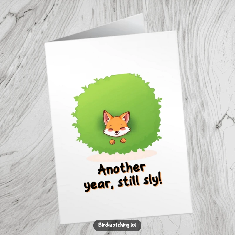 Funny Free Printable Birthday Card: A giggling fox peeks playfully from behind a large green bush, perfect for a humorous celebration.