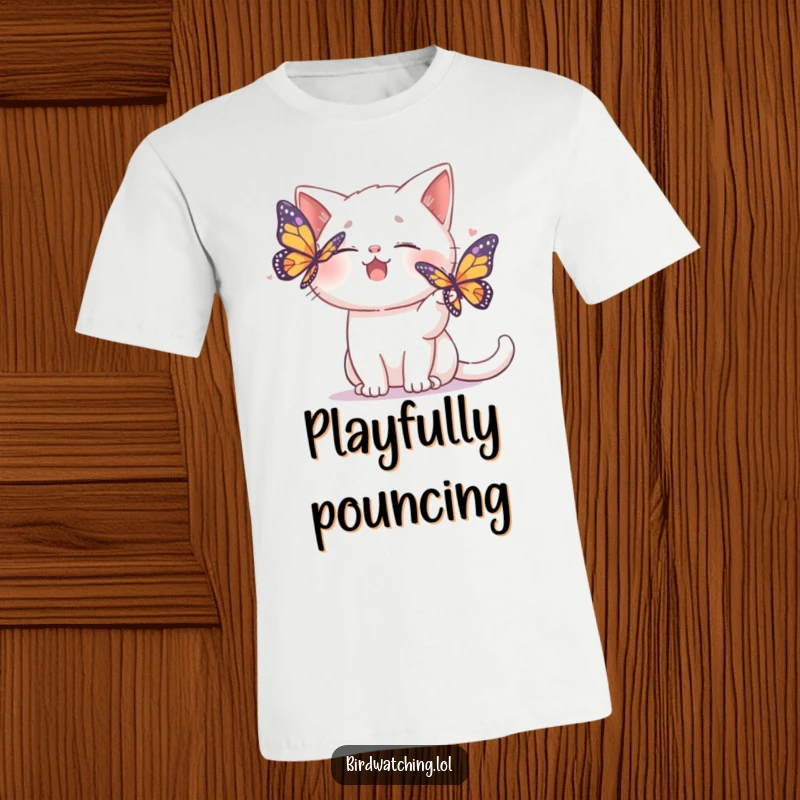 Funny t-shirt showing a giggling cat playfully batting at a colorful butterfly, full of mischief.