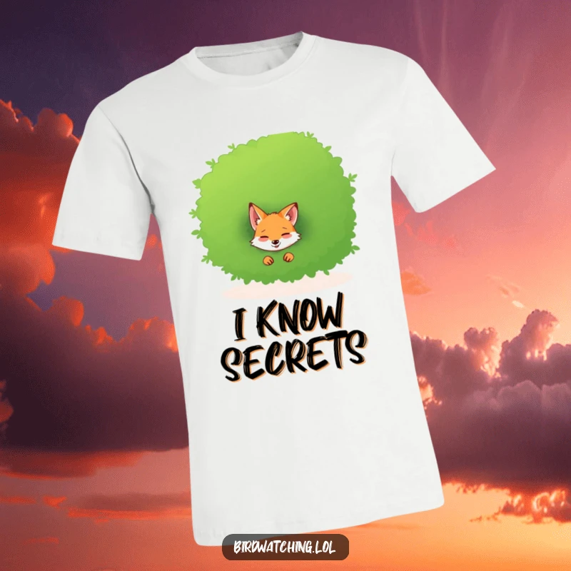 Funny t-shirt with a giggling fox emerging from behind a large bush, sharing a secret laugh.